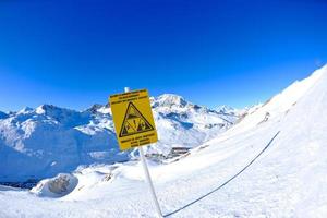 Sign board at High mountains under snow in the winter photo