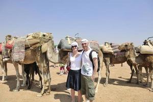 Posing with camels photo