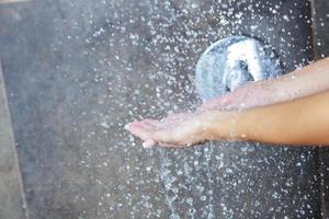 sexy young woman enjoing bath under water shower photo