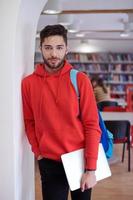 the student uses a laptop and a school library photo