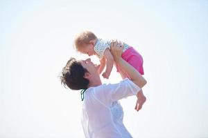 mom and baby on beach  have fun photo