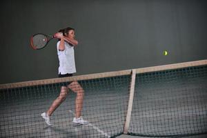 Playing tennis indoors photo