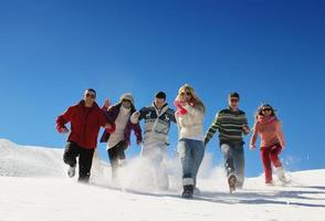 friends have fun at winter on fresh snow photo