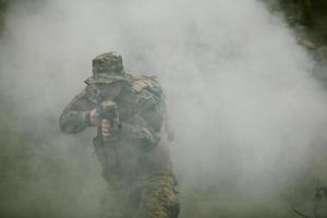 soldier in action aiming  on weapon  laser sight optics photo