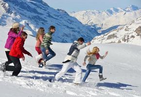 friends have fun at winter on fresh snow photo