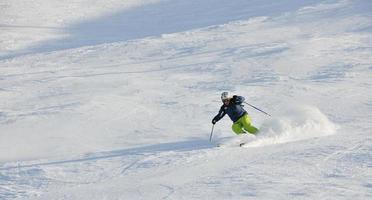 skiing on fresh snow at winter season at beautiful sunny day photo