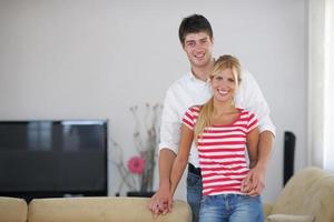Relaxed young  couple watching tv at home photo