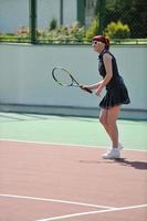 young woman play tennis game outdoor photo