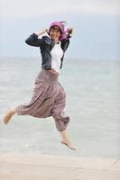 beautiful young woman on beach with scarf photo