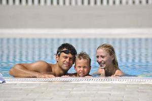 happy young family have fun on swimming pool photo