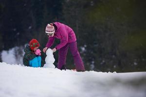 happy family building snowman photo