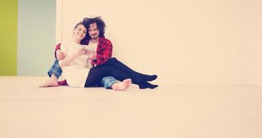 Young Couple using digital tablet on the floor photo