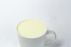 Fresh glass of milk isolated over white background photo