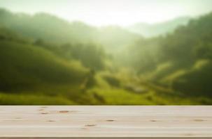 Empty wooden table with view of mountain or wooden desk with plantation nature with bokeh background, copy space for your text photo