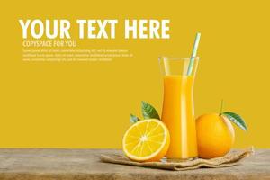 Glass of fresh orange juice on wooden table, Fresh fruits Orange juice in glass with group on yellow background with copy Space for your text. photo