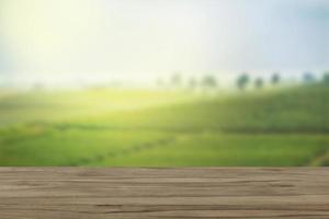 Empty wooden table with view of mountain or wooden desk with plantation nature with bokeh background, copy space for your text photo