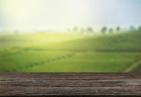 Empty wooden table with view of mountain or wooden desk with plantation nature with bokeh background, copy space for your text photo