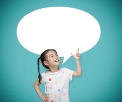 Asian child girl pointing at the blackboard with imagination the empty speech bubble,, Creative and dreams of childhood concept photo