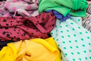 Detailed close up view on samples of cloth and fabrics in different colors found at a fabrics market photo