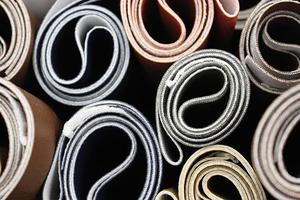 Detailed close up view on samples of cloth and fabrics in different colors found at a fabrics market photo