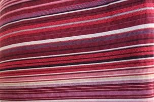 Detailed close up view on samples of cloth and fabrics in different colors found at a fabrics market photo