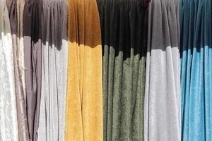Detailed close up view on samples of cloth and fabrics in different colors found at a fabrics market photo
