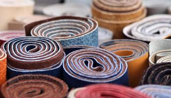 Detailed close up view on samples of cloth and fabrics in different colors found at a fabrics market photo