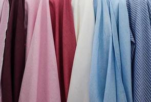 Detailed close up view on samples of cloth and fabrics in different colors found at a fabrics market photo