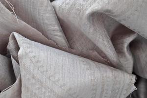Detailed close up view on samples of cloth and fabrics in different colors found at a fabrics market photo