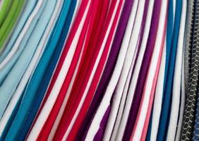 Detailed close up view on samples of cloth and fabrics in different colors found at a fabrics market photo