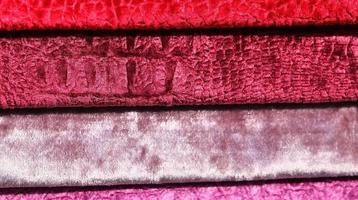Detailed close up view on samples of cloth and fabrics in different colors found at a fabrics market photo
