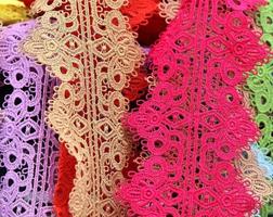 Detailed close up view on samples of cloth and fabrics in different colors found at a fabrics market photo