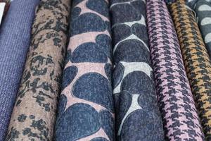 Detailed close up view on samples of cloth and fabrics in different colors found at a fabrics market photo