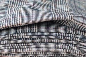 Detailed close up view on samples of cloth and fabrics in different colors found at a fabrics market photo
