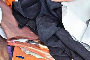 Detailed close up view on samples of cloth and fabrics in different colors found at a fabrics market photo