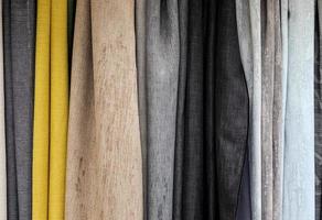 Detailed close up view on samples of cloth and fabrics in different colors found at a fabrics market photo