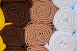Detailed close up view on samples of cloth and fabrics in different colors found at a fabrics market photo