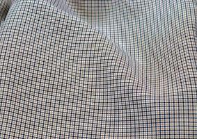 Detailed close up view on samples of cloth and fabrics in different colors found at a fabrics market photo