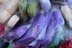 Detailed close up view on samples of cloth and fabrics in different colors found at a fabrics market photo