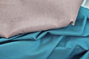 Detailed close up view on samples of cloth and fabrics in different colors found at a fabrics market photo