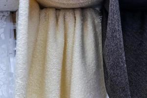 Detailed close up view on samples of cloth and fabrics in different colors found at a fabrics market photo