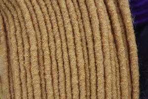 Detailed close up view on samples of cloth and fabrics in different colors found at a fabrics market photo