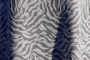 Detailed close up view on samples of cloth and fabrics in different colors found at a fabrics market photo