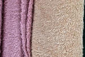 Detailed close up view on samples of cloth and fabrics in different colors found at a fabrics market photo