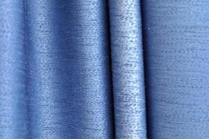 Detailed close up view on samples of cloth and fabrics in different colors found at a fabrics market photo