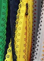 Detailed close up view on samples of cloth and fabrics in different colors found at a fabrics market photo