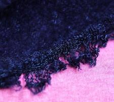 Detailed close up view on samples of cloth and fabrics in different colors found at a fabrics market photo