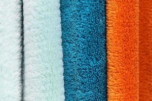 Detailed close up view on samples of cloth and fabrics in different colors found at a fabrics market photo