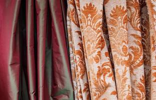 Detailed close up view on samples of cloth and fabrics in different colors found at a fabrics market photo