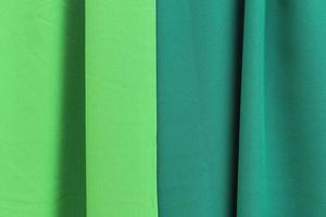Detailed close up view on samples of cloth and fabrics in different colors found at a fabrics market photo